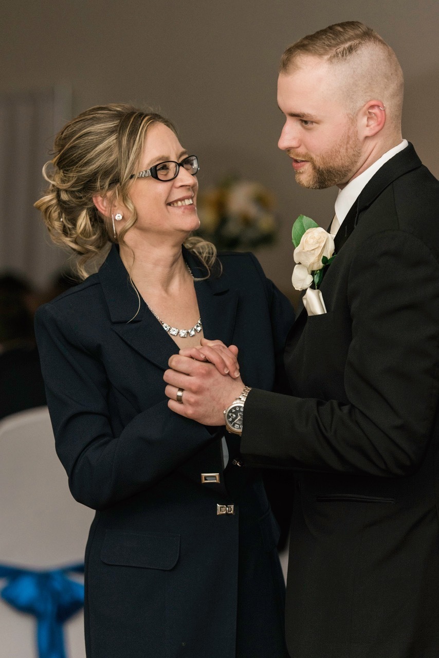 A groom dances with his mom